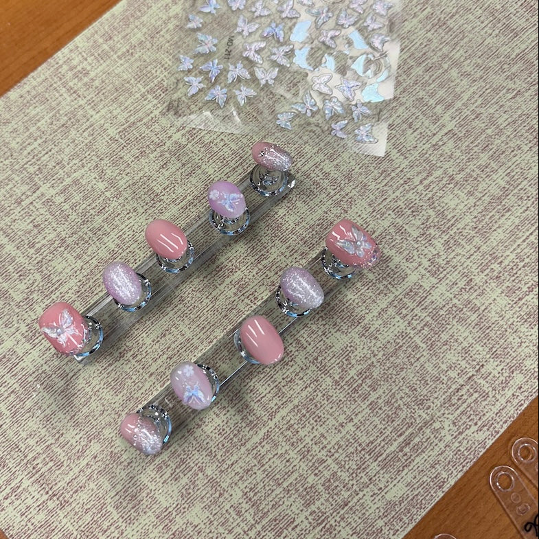 Set of hair clips with pink and clear designs on a textured surface